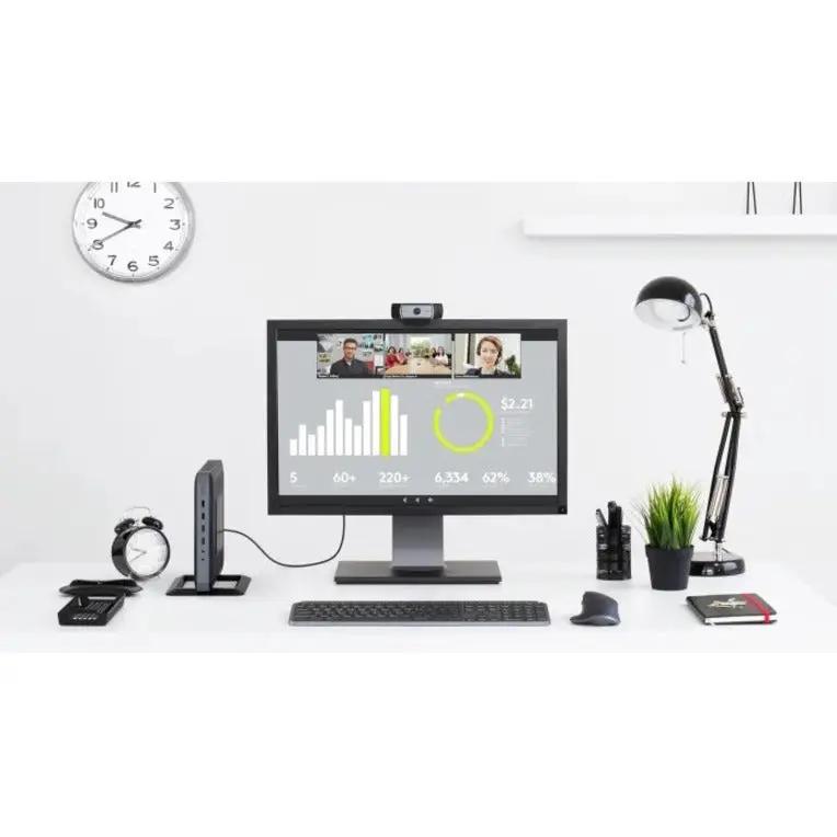 Logitech C930e business webcam mounted on top of a black computer monitor on a white desk.