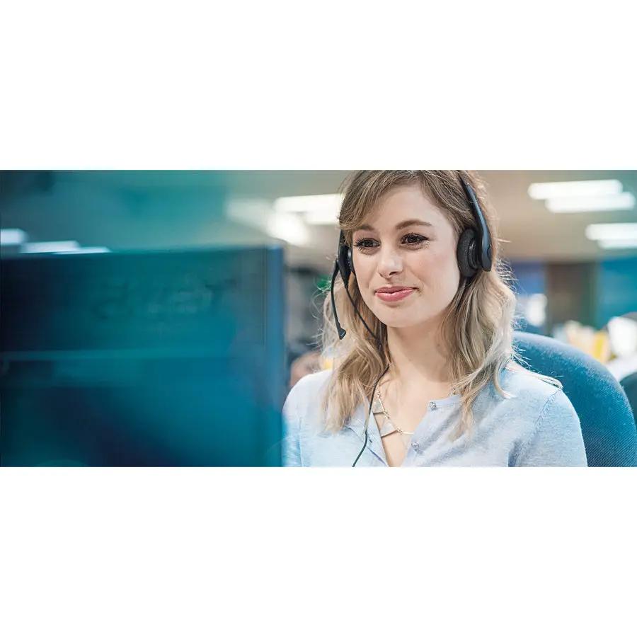 Biz 1500 Duo QD black headset with microphone by Jabra worn by a woman at a computer in an office