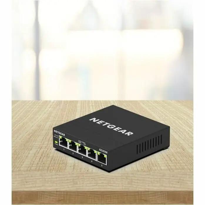 NETGEAR GS305E 5-Port Managed Ethernet Switch on a wooden desk
