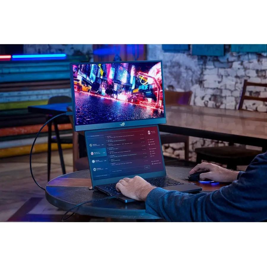 ASUS ROG Strix XG17AHP 17-inch portable gaming monitor connected to a laptop on a round table
