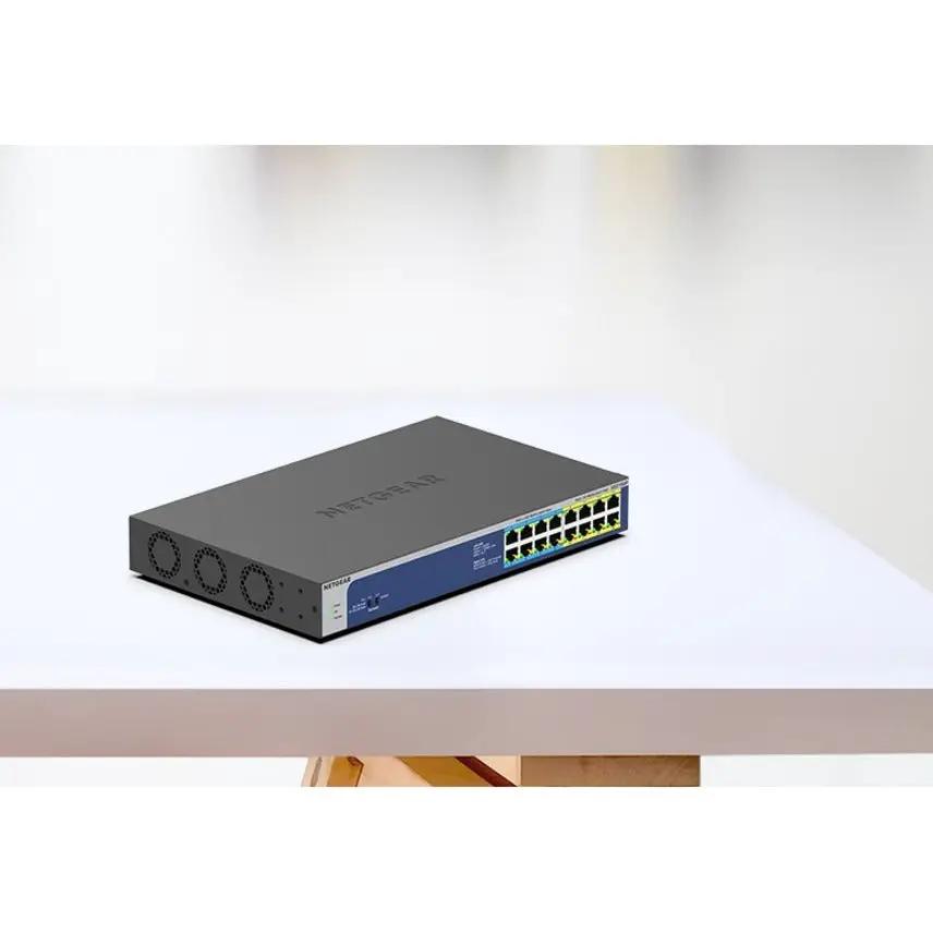 NETGEAR ProSAFE GS516UP 16-port Gigabit PoE+ unmanaged switch with blue front panel on a table
