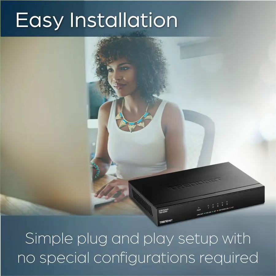 TRENDnet TEG-S350 5-Port 2.5G unmanaged switch, black, on a desk beside a computer