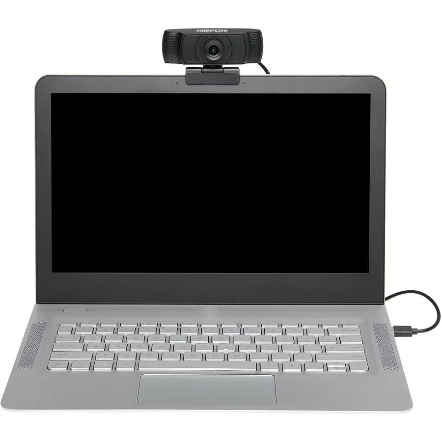 TrippLite USB webcam with microphone atop a silver laptop.
