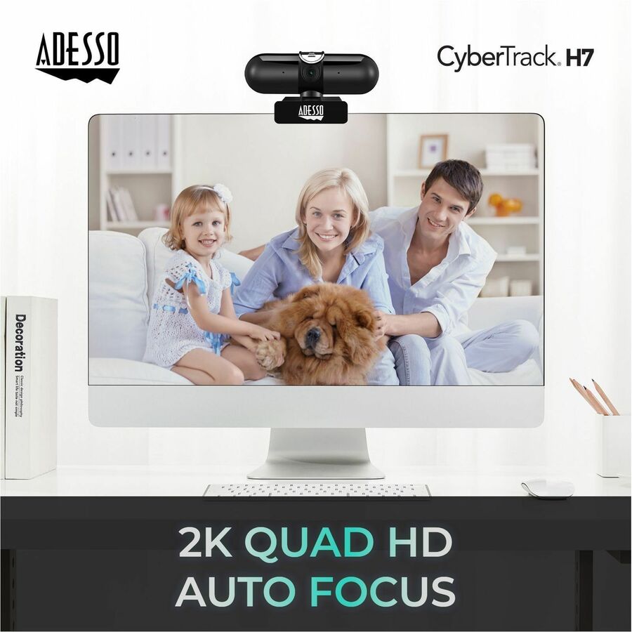 Adesso CyberTrack H7 webcam, black, mounted on top of a silver computer monitor on a white desk.