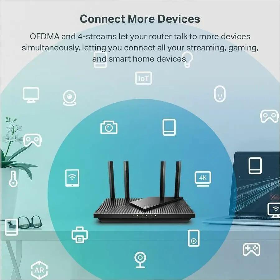 TP-Link Archer AX55 wireless router, black, with four antennas on a glass desk beside a laptop.