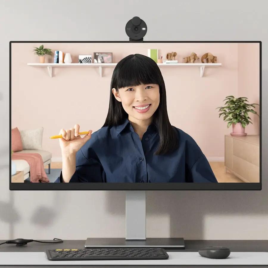 Logitech Brio 300 webcam in graphite on top of a monitor in a home office setup
