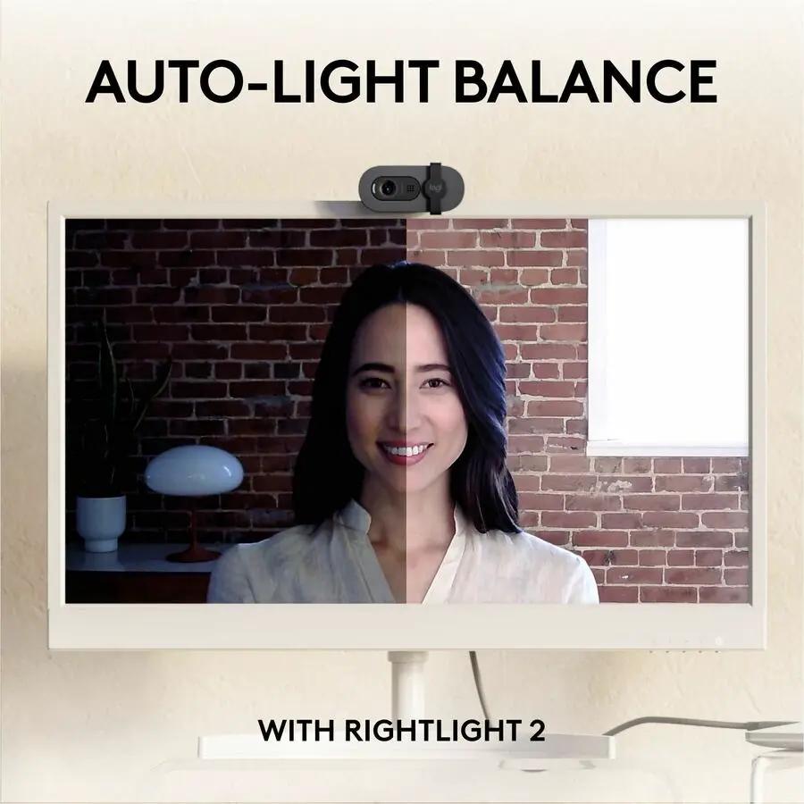 Logitech Brio 105 webcam mounted on top of a computer monitor displaying auto-light balance.