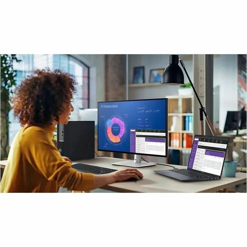 Dell UltraSharp U2724DE 27-inch WQHD monitor with black body and silver stand on a desk.