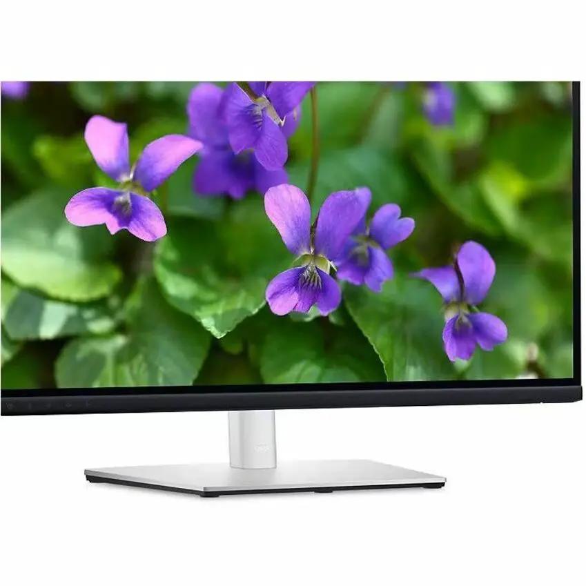 Dell P2724DEB 27-inch WQHD monitor with black bezel and silver stand, displaying purple flowers.