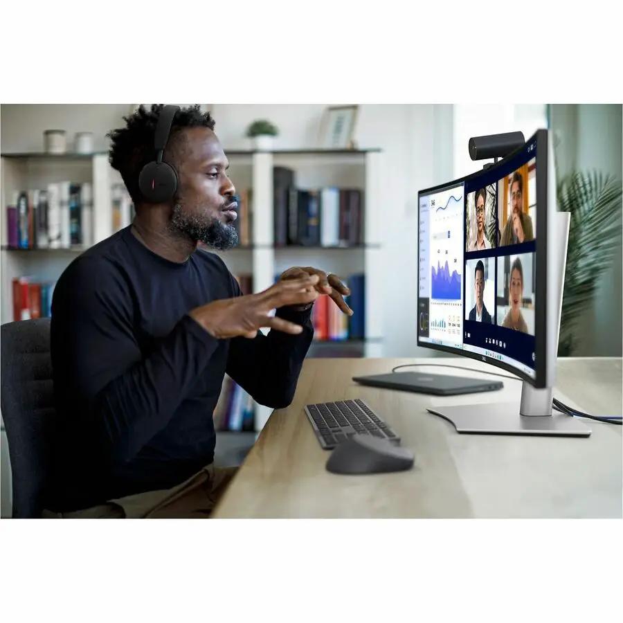 Dell UltraSharp U3425WE 34-inch UW-QHD curved LED monitor on a silver stand during a video conference