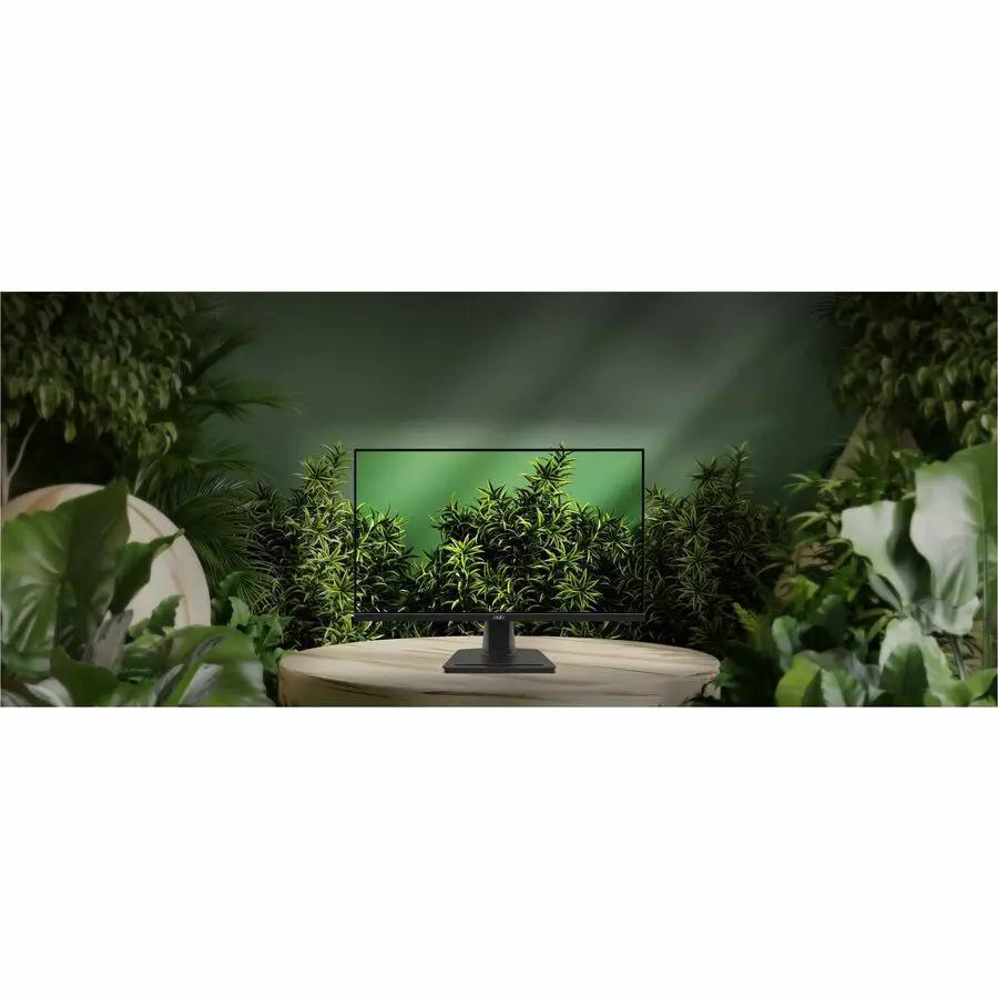 MSI Pro MP275Q 27-inch WQHD 100Hz monitor in matte black on a wooden table, surrounded by green plants.
