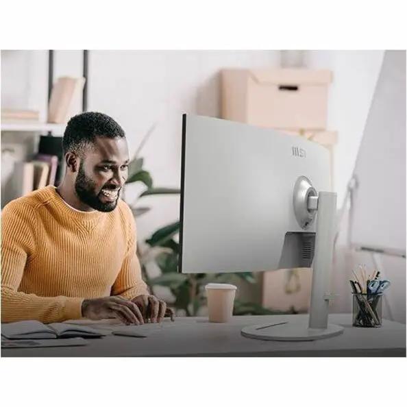 MSI Modern MD342CQPW 34-inch UW-QHD curved monitor on a desk, silver-gray finish with MSI logo