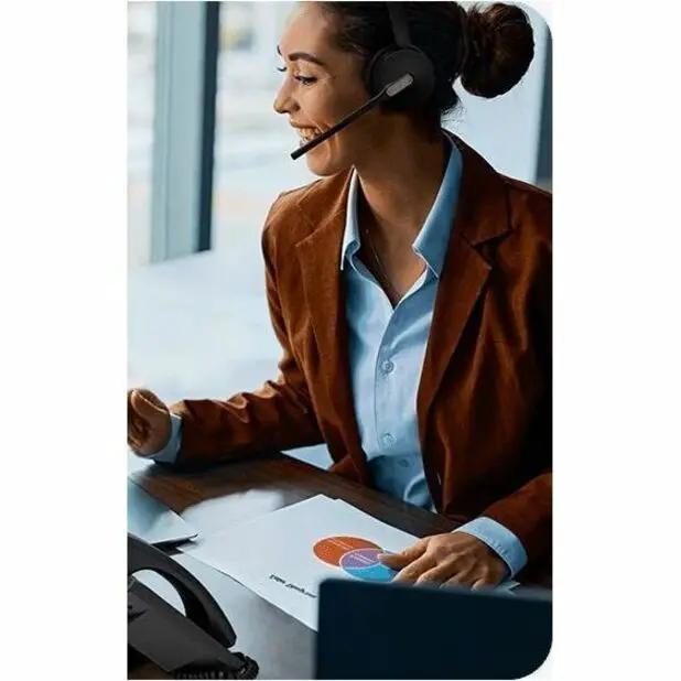 Yealink WH64 Hybrid Dual Teams headset worn by a person at a desk, black.