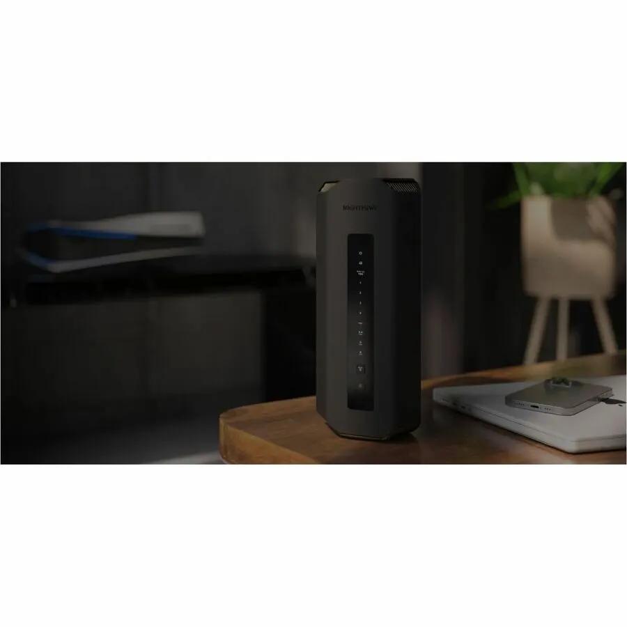 Netgear Nighthawk RS200 Wi-Fi 7 router, black vertical unit with LED indicators on a desk