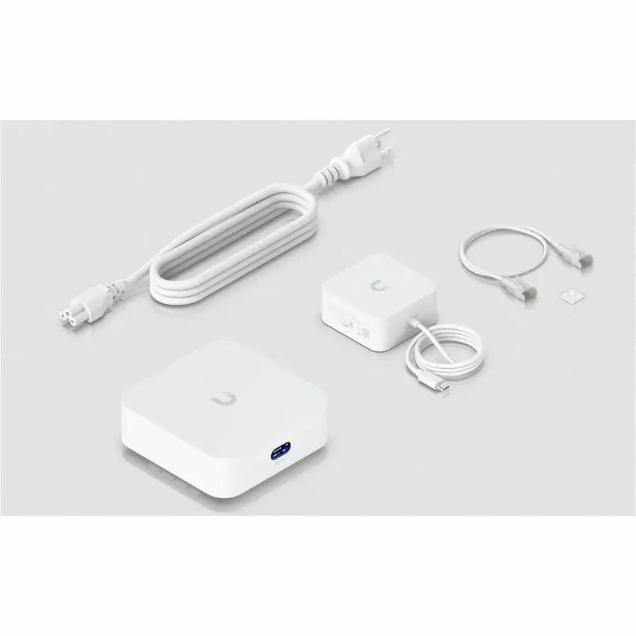 Ubiquiti UniFi Express7 10GbE gateway with white power adapter and Ethernet cables