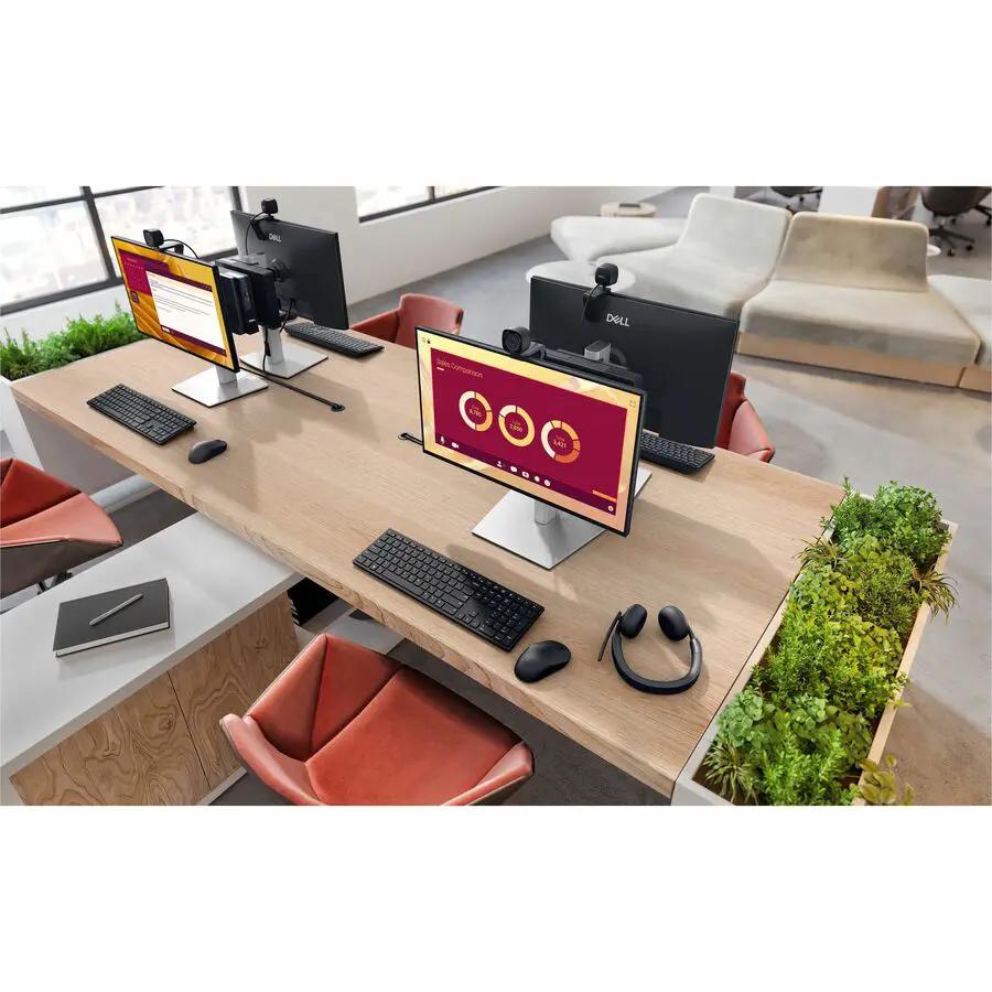 Dell QCM1255 Pro Micro desktop computers (4) on a long office desk with monitors and keyboards.