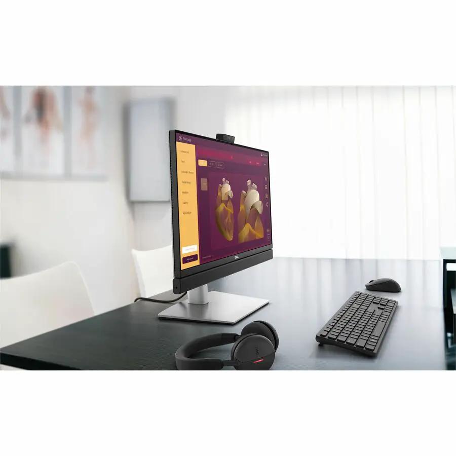 Dell QB24250 Pro 24 All-in-One desktop computer with black keyboard and headset on desk