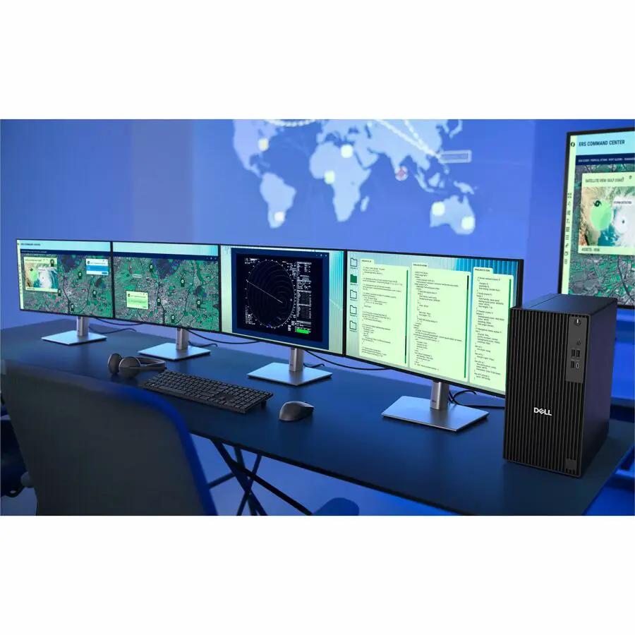 Dell QBT1250 Pro Tower Plus desktop PC with 32GB DDR5 and 1TB NVMe, black tower beside a multi-monitor workstation