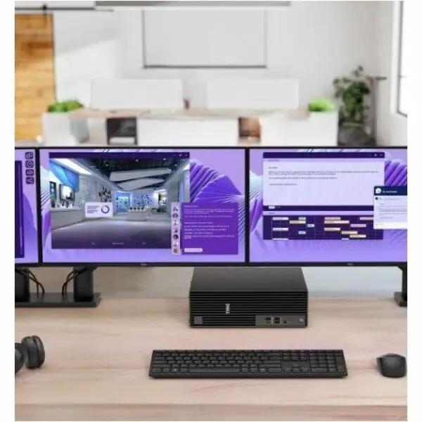 Dell QBS1250 Slim AI Desktop on a desk with a dual-monitor setup, black compact PC with keyboard and mouse