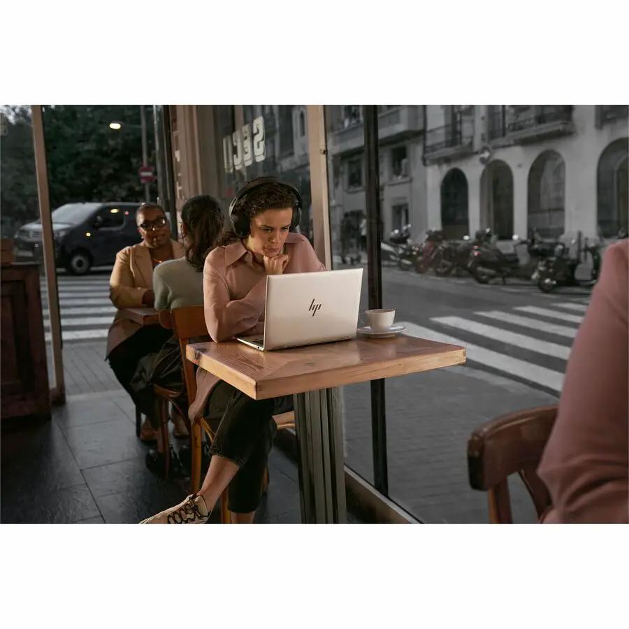 HP EliteBook Laptop, silver aluminum with HP logo, on cafe table