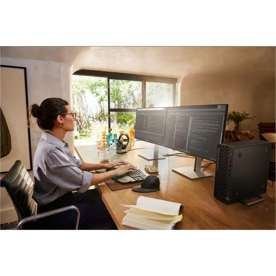 HP EliteDesk 8 SG1i slim desktop on a wooden desk with two monitors in office setup