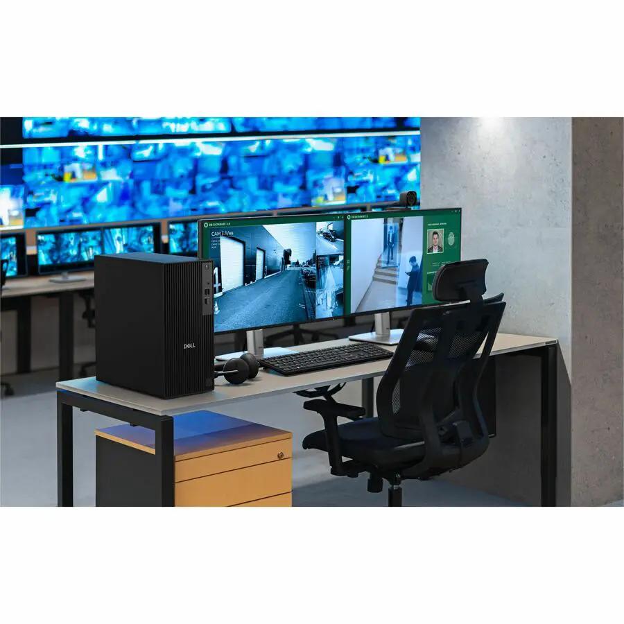 Dell QCT1250 Pro Tower desktop computer on a desk with multiple monitors in a control room