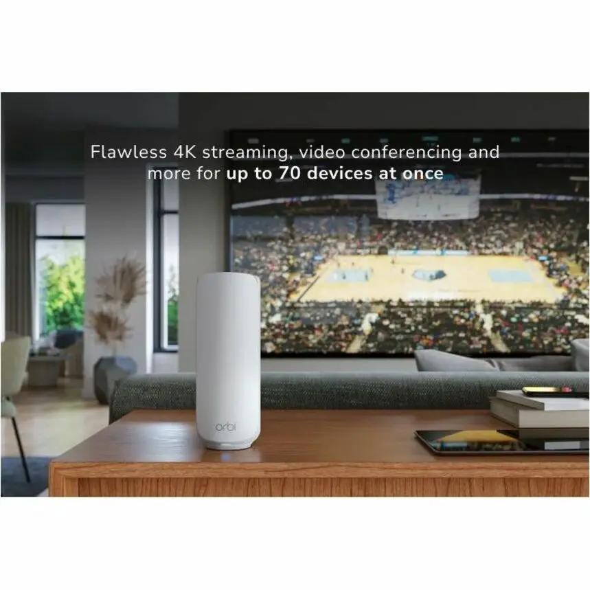 NETGEAR Orbi wireless router, white cylindrical device on a wooden coffee table