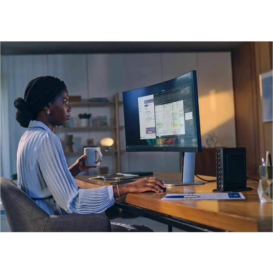 HP EliteDesk G1a Mini PC, black, on a desk beside a monitor in an office setup