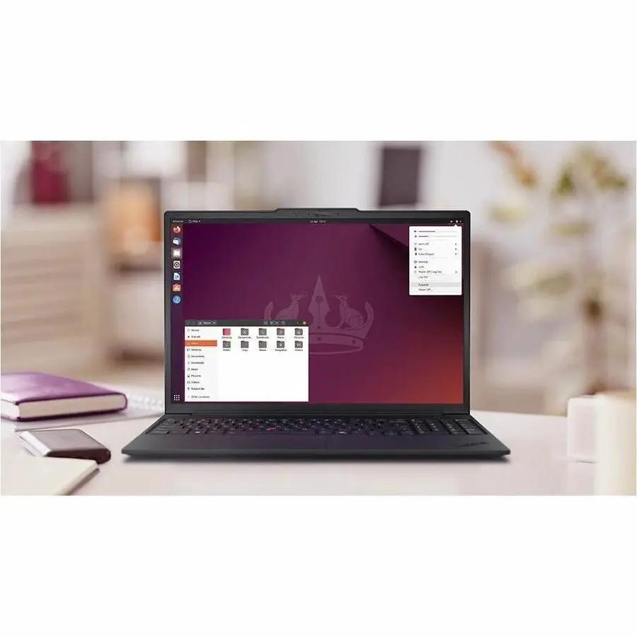 Lenovo ThinkPad P16v G3 laptop, black, open with Ubuntu desktop on desk.