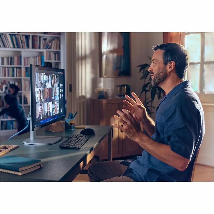 HP EliteStudio G1i All-in-One PC with silver finish on desk during a virtual meeting in a home office