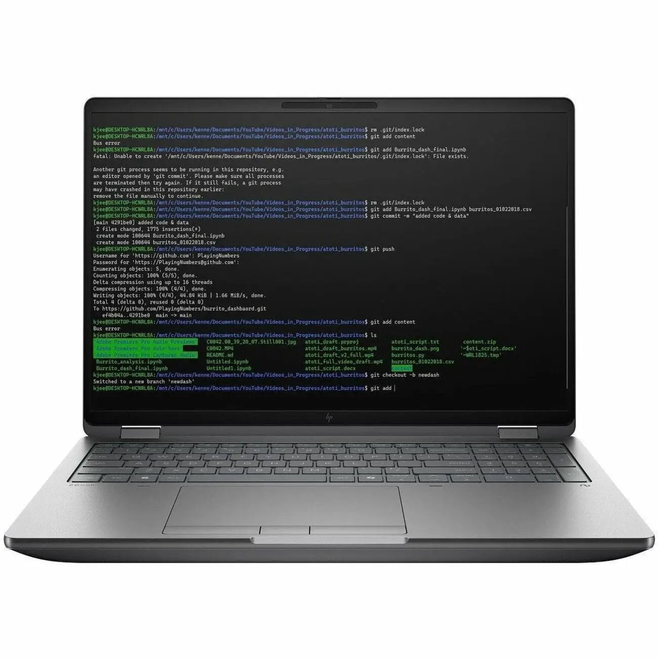 HP ZBook Fury 16 laptop with silver chassis, 32GB RAM and 1TB SSD, open with lines of code on display