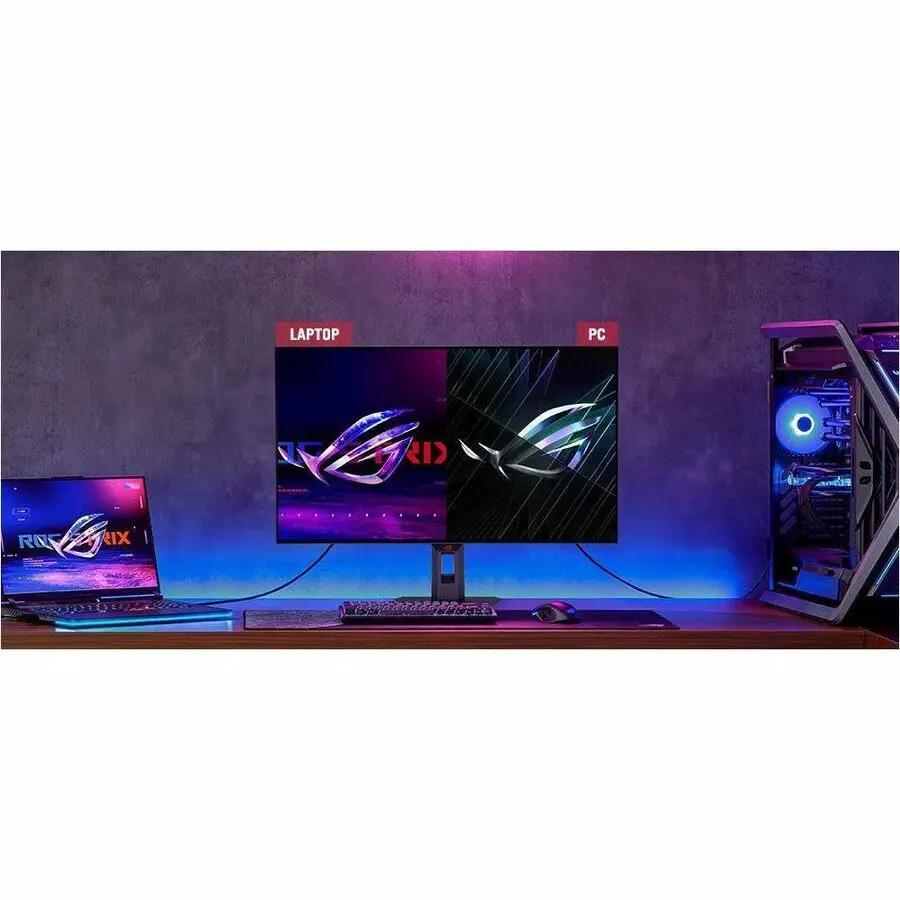 ASUS ROG Strix XG32UCWMG 32 inch OLED monitor on a desk with a laptop left and PC right, black bezel