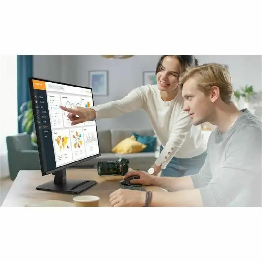 MSI Pro MP242 E14A 24-inch FHD monitor in matte black on desk with two people collaborating.