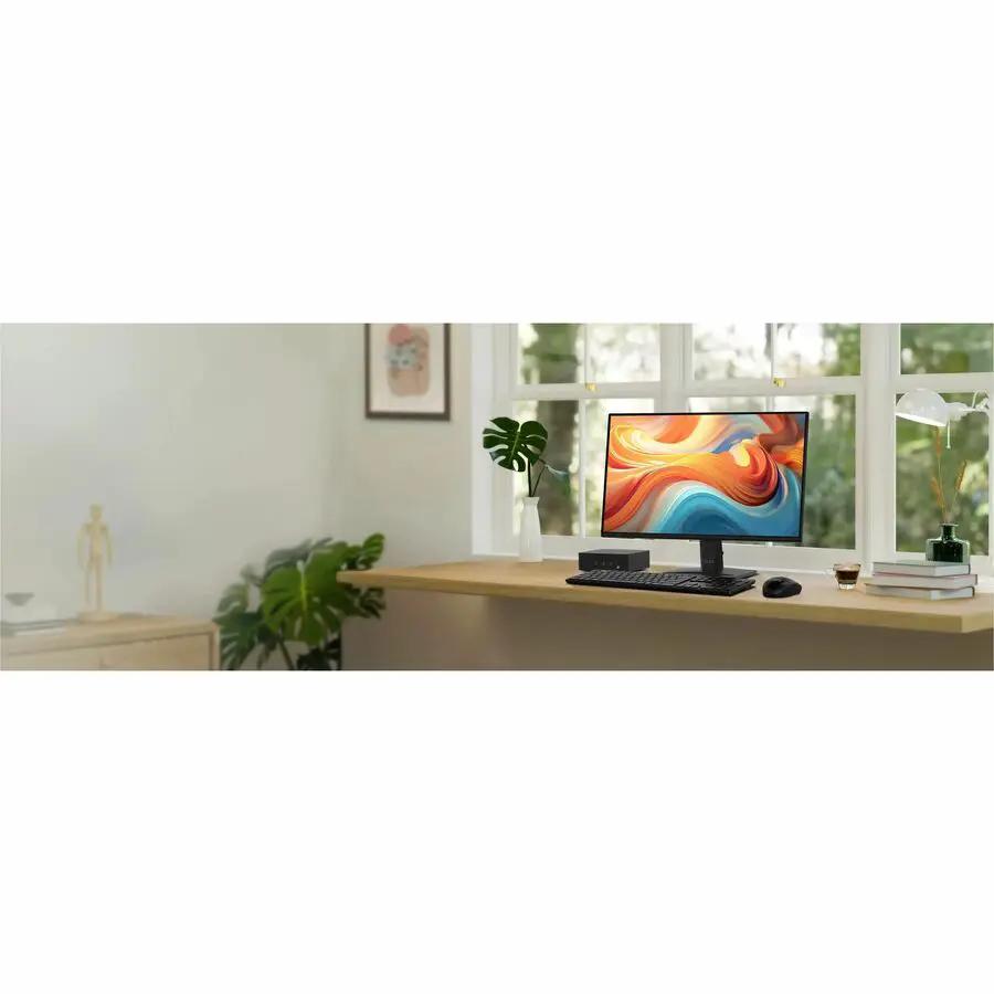 MSI Pro MP242 E14A 24-inch black monitor on a wooden desk with keyboard and mouse