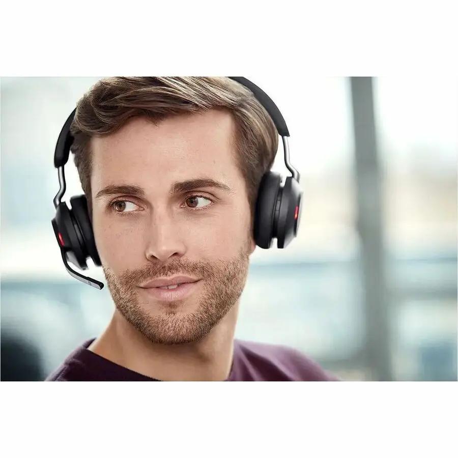 Jabra Evolve2 65 UC Stereo headset, black over-ear with boom microphone worn by man