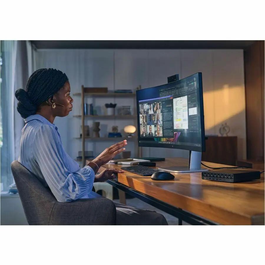 HP EliteDesk 8 G1a mini desktop PC black compact on a desk beside a monitor