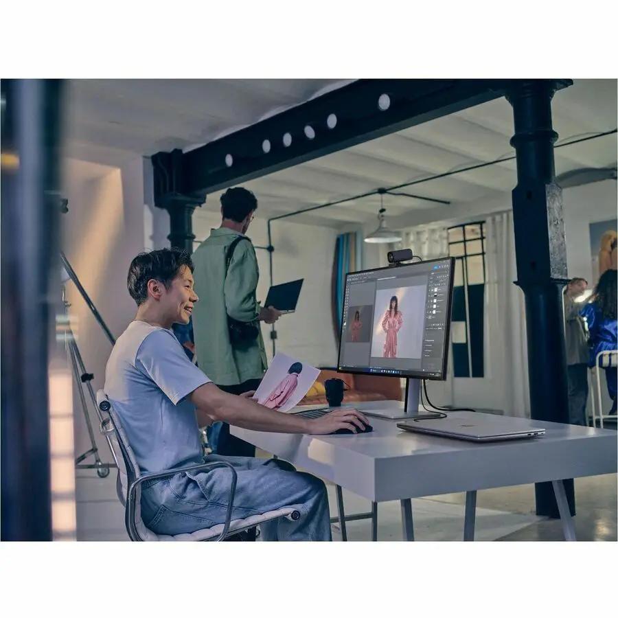 HP 732xk 32-inch 4K UHD monitor, black, on a white desk with a webcam.