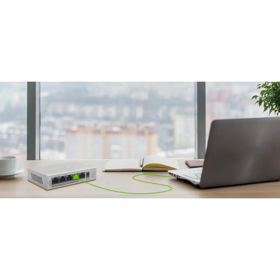Zyxel GS1005HP 5-Port Gigabit PoE+ Unmanaged Switch on desk with grey metal housing and green PoE cable.
