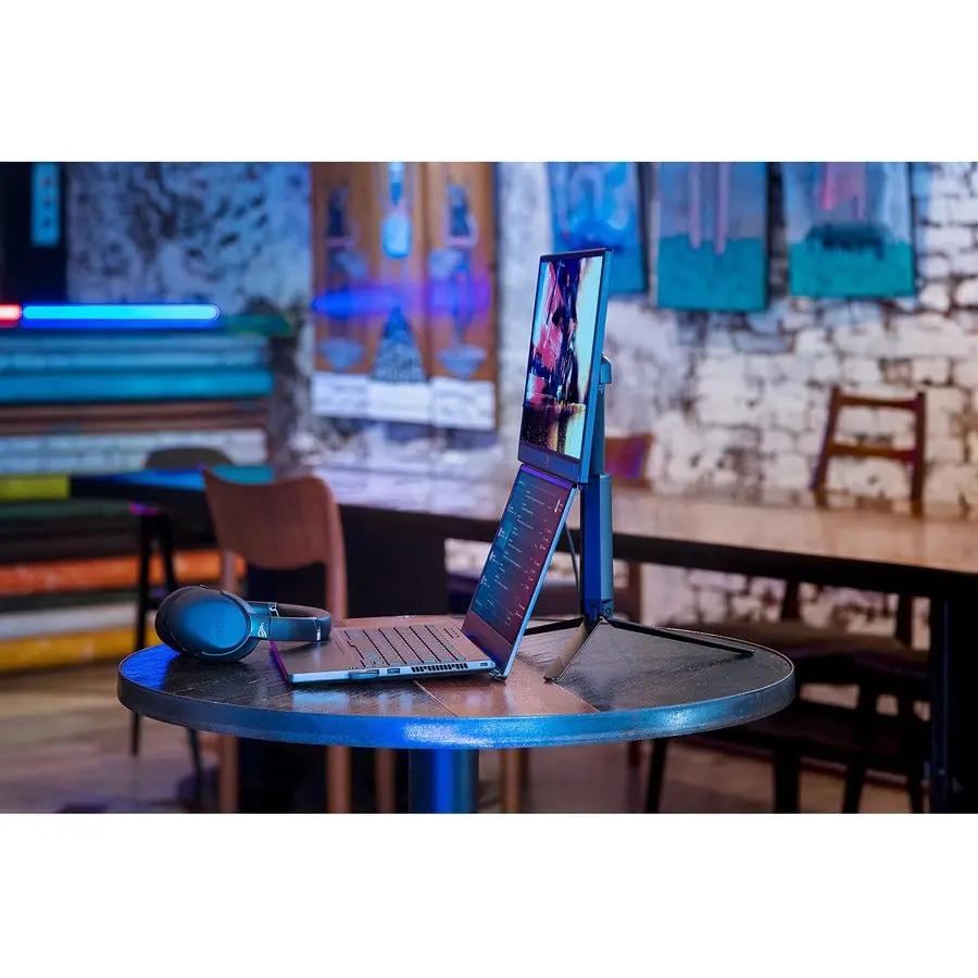 ASUS ROG Strix XG17AHP 17-inch portable gaming monitor on round table with laptop and headphones