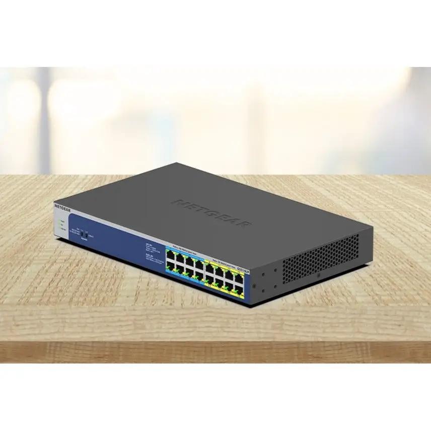 NETGEAR ProSAFE GS516UP 16-port Gigabit PoE+ unmanaged switch with blue front panel on wood desk