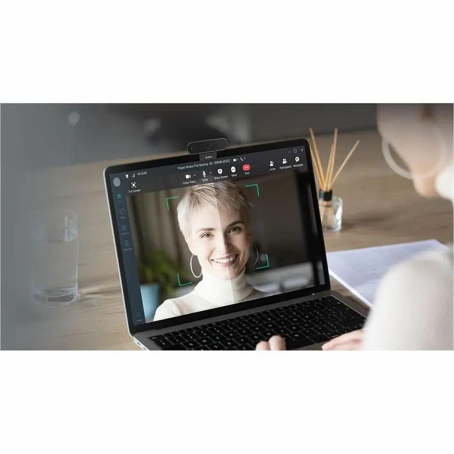 Yealink UVC20 USB webcam mounted on top of a laptop during a video call.