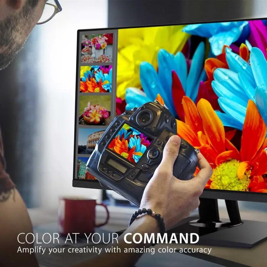 ViewSonic VP2756 27-inch 4K UHD IPS monitor on a desk; person holds a camera in front of the screen.