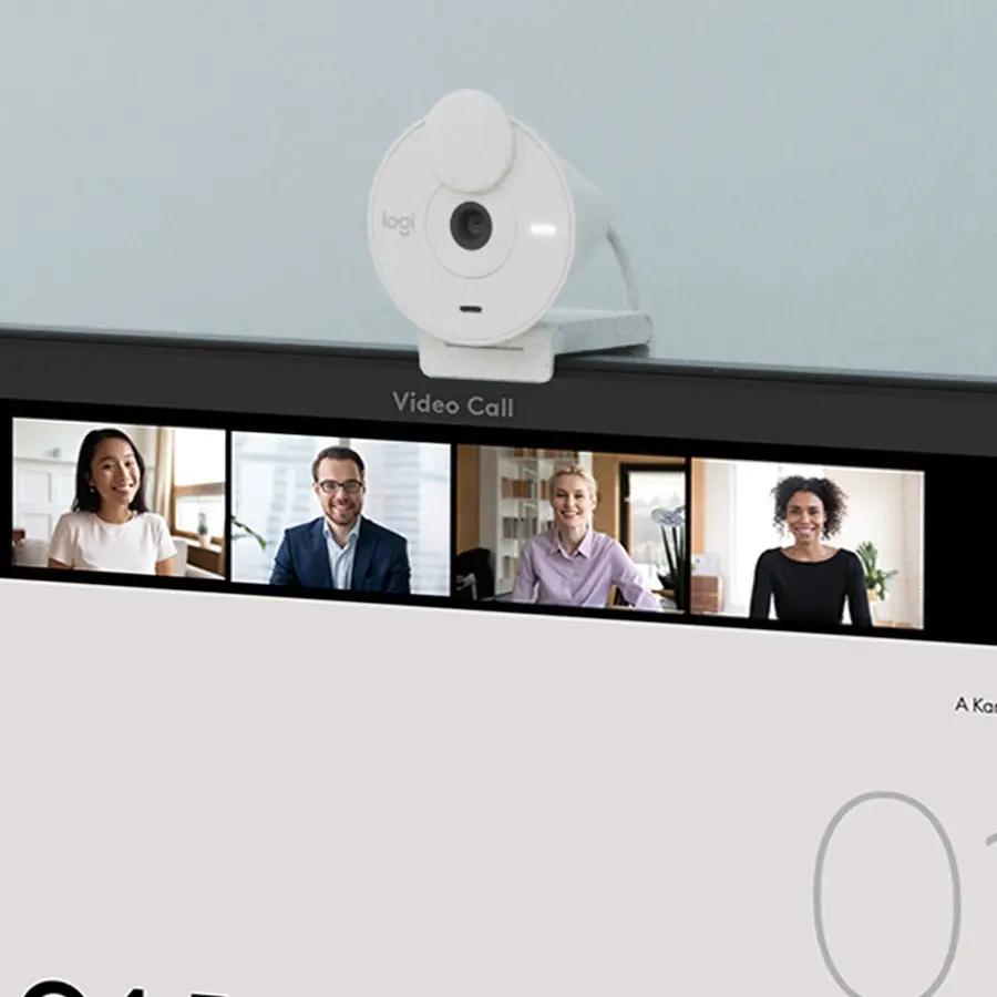 Logitech BRIO webcam in white mounted on top of a monitor during a video call.