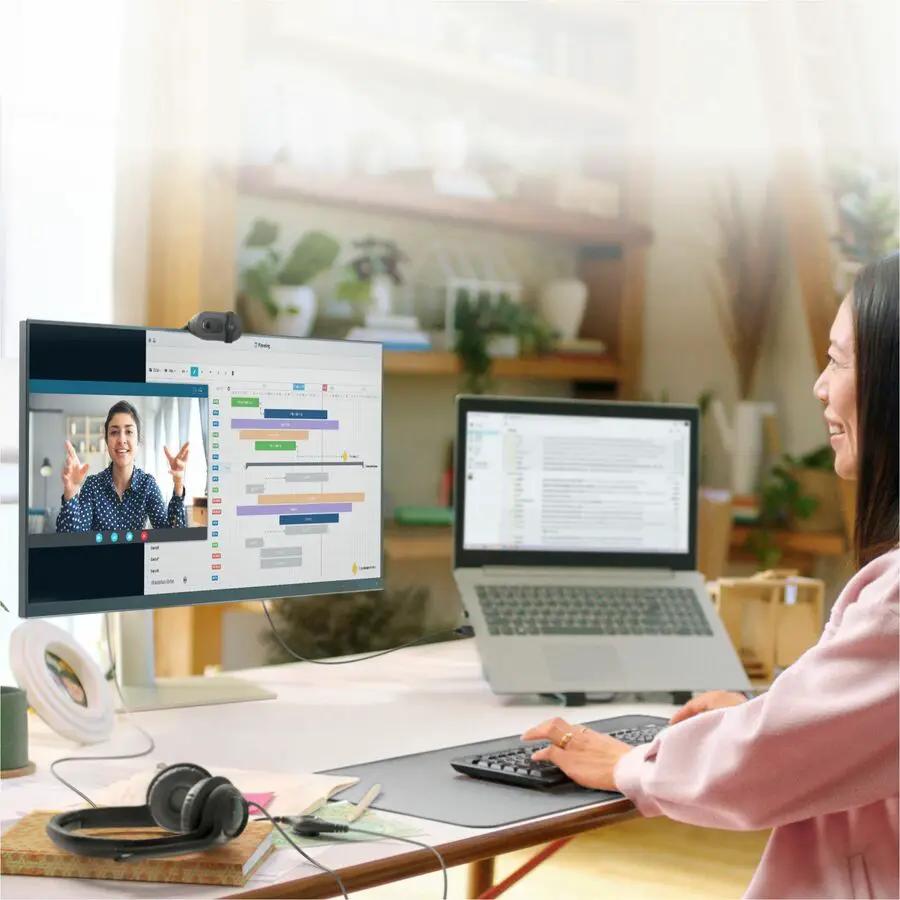 Logitech BRIO 100 webcam, graphite, USB Type-A, on monitor.
