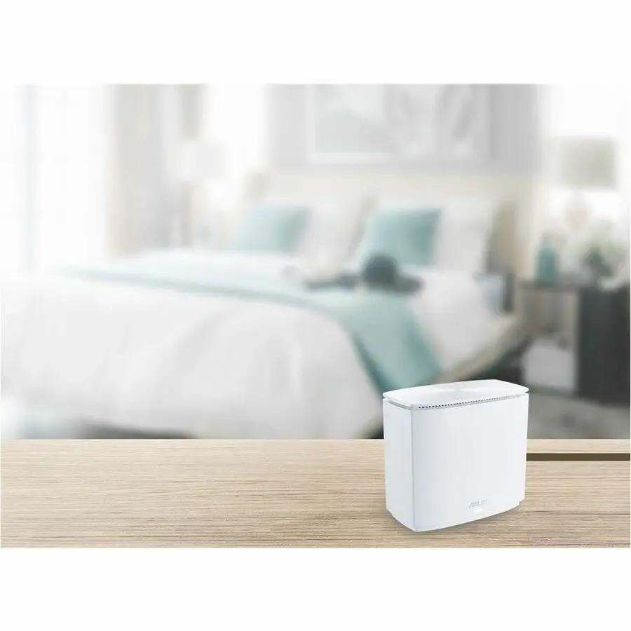 ASUS ZenWiFi XC5 AX3000 WiFi 6 AiMesh router in white on a wooden desk