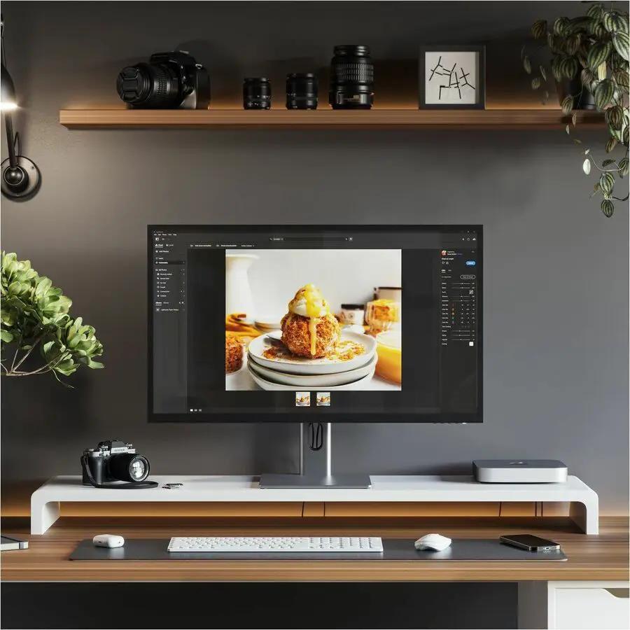 Alogic Clarity 32-inch 4K UHD monitor on a modern home-office desk with a camera, keyboard, and mouse