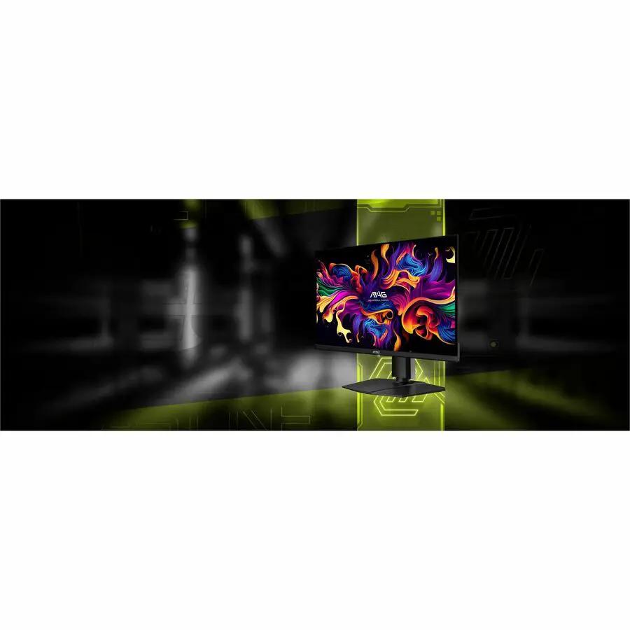 MSI MAG 271QPX 27-inch WQHD OLED gaming monitor on a stand in a dark studio with green neon lighting