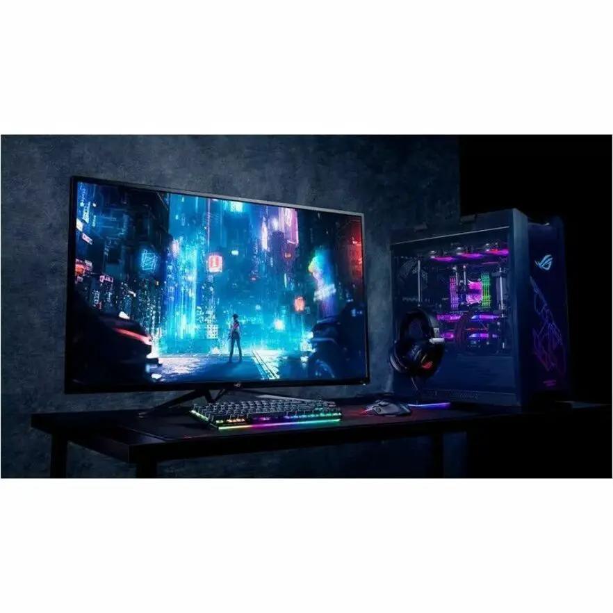 ASUS ROG Swift PG32UCDM monitor and gaming PC on desk with RGB lighting