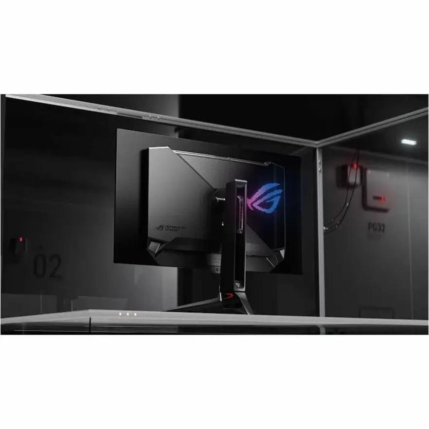 ASUS ROG Swift PG32UCDM 32-inch 4K UHD OLED gaming monitor rear view with illuminated ROG logo on black backdrop