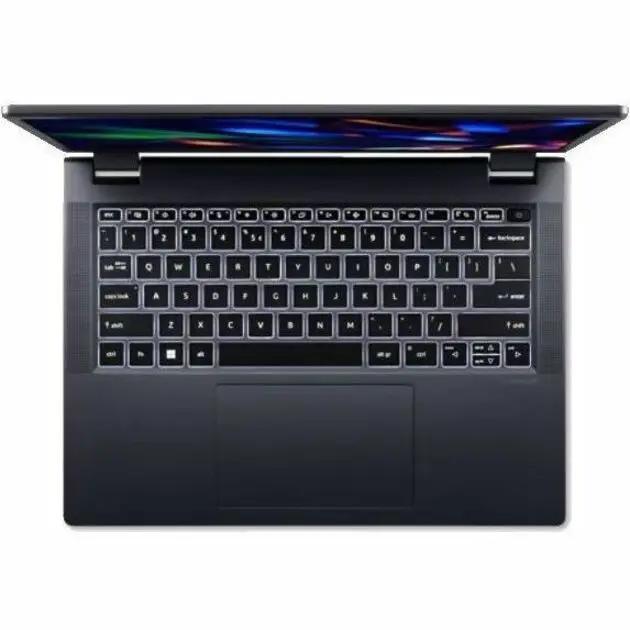 Acer TravelMate 16 laptop, dark gray chassis, 16GB RAM, 1TB SSD, top-down view of keyboard and trackpad